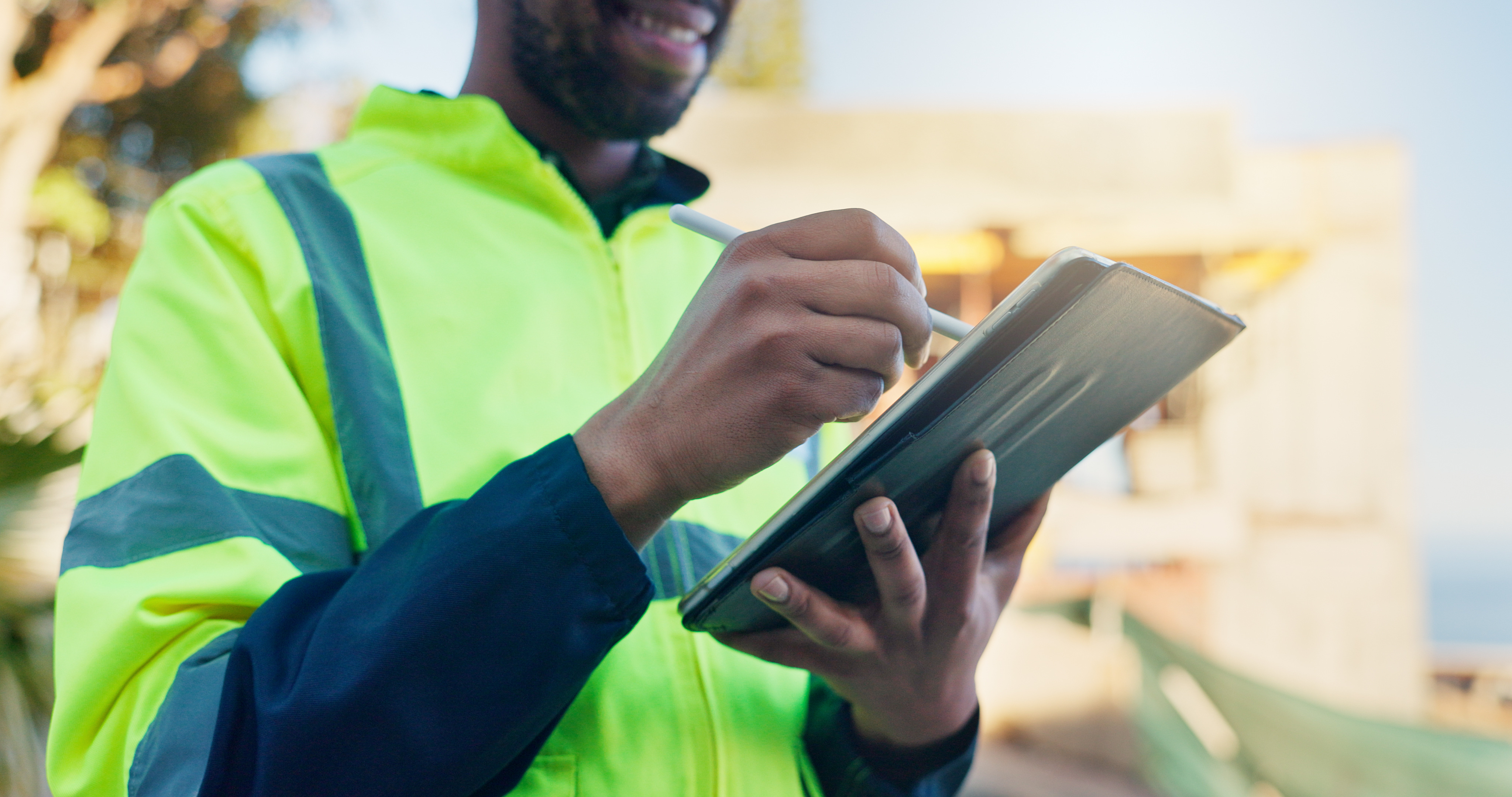 Field technician recording work on a digital tablet